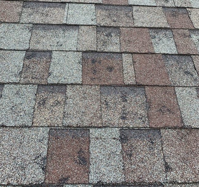 Storm damage can cause loose and cracked shingles.